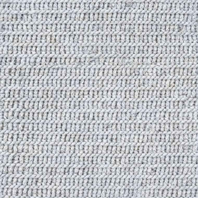 Precisely knitted fabric close-up in cold light
