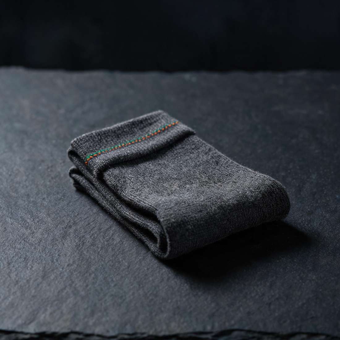 Premium NOSOX socks close-up: a pair on a dark surface